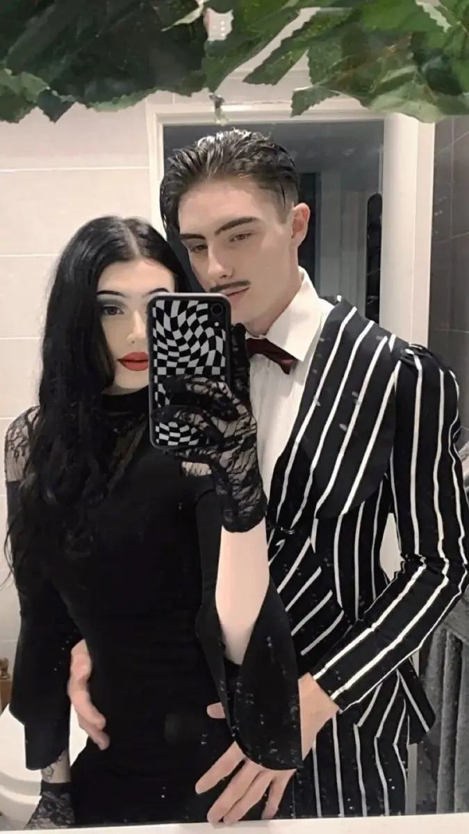 Two women in black dresses as Wednesday and Morticia Addams mother daughter costume 17