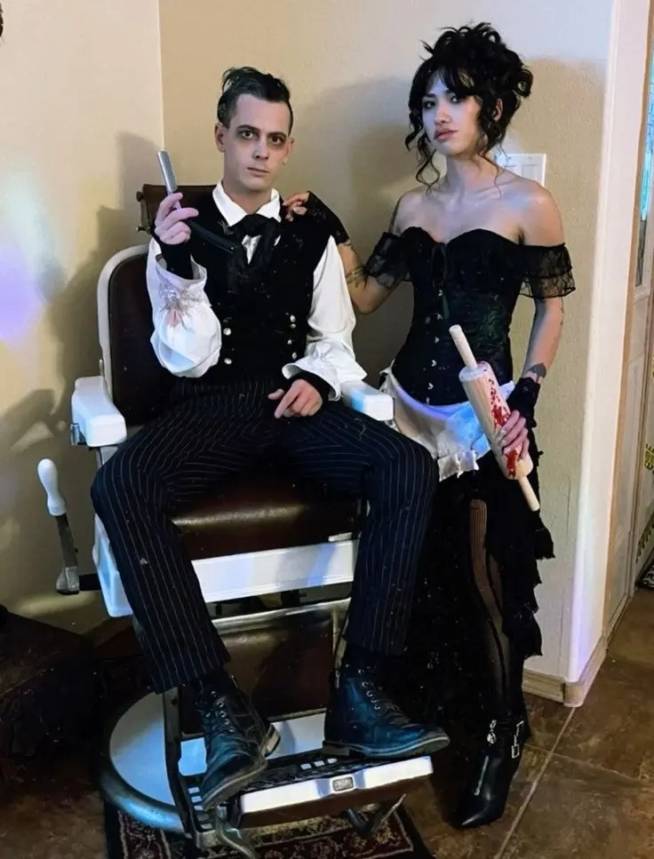 Couple in black gothic clothing with pale makeup as Tim Burton style characters costume 19