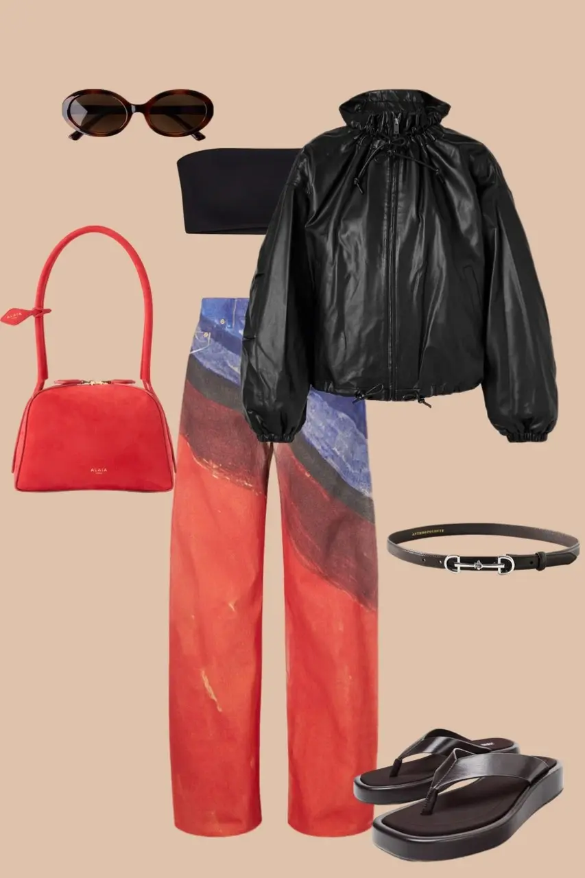 Multi-colored printed wide leg jeans with black oversized puffer jacket oval sunglasses red structured bag thin belt black sandals statement outerwear outfit 5