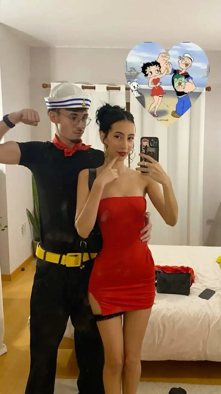 man in sailor costume with red bandana flexing next to woman in red strapless dress taking mirror selfie outfit 7
