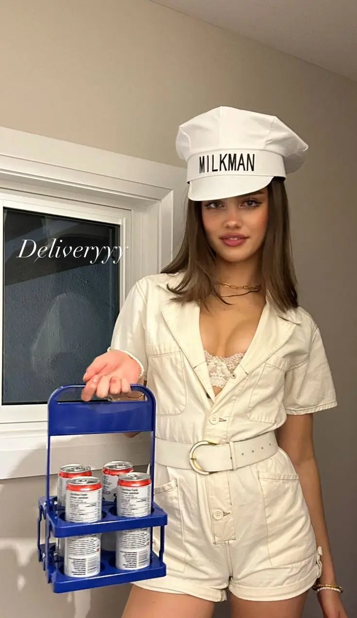 white belted romper with milkman hat milk crate prop white uniform style outfit 6