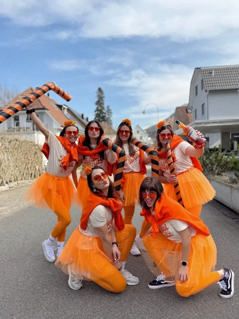 group of women in orange cheetos themed costumes with tutus and orange accessories outfit 11