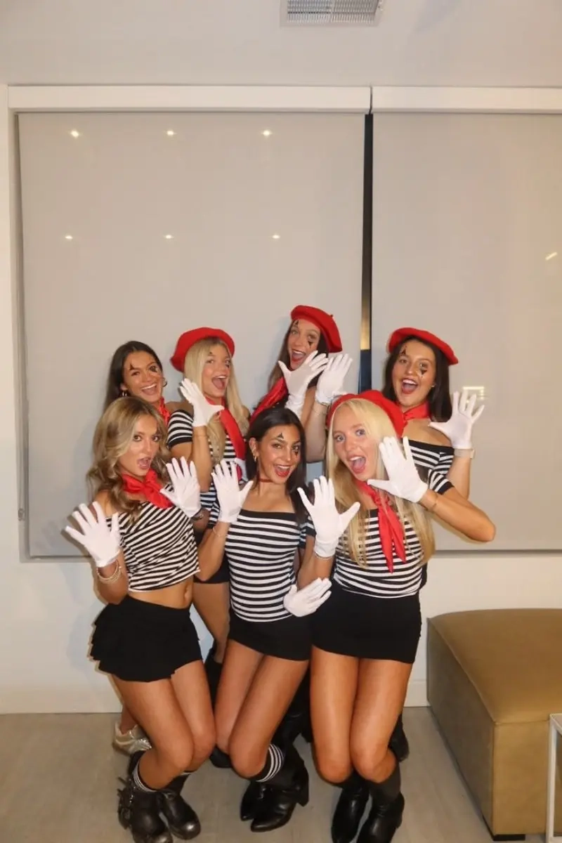 group of women in mime costumes with striped shirts red berets and white gloves posing outfit 8