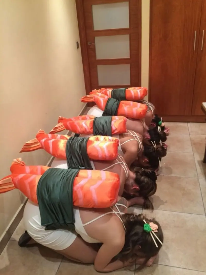 group of women wearing inflatable sushi roll costumes kneeling on floor outfit 3