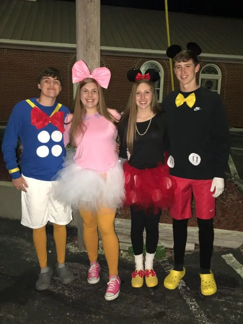 four people in mickey mouse character costumes with ears tutus and character colors outfit 5