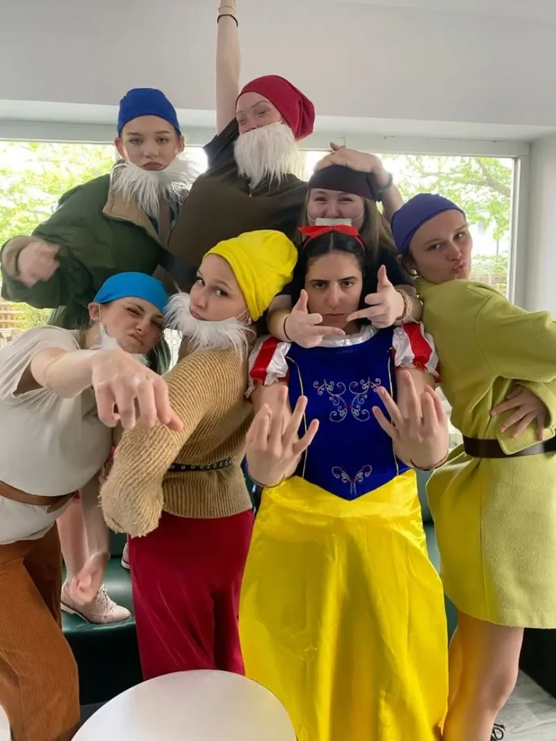 group wearing snow white and seven dwarfs costumes with colored hats beards and snow white dress outfit 9