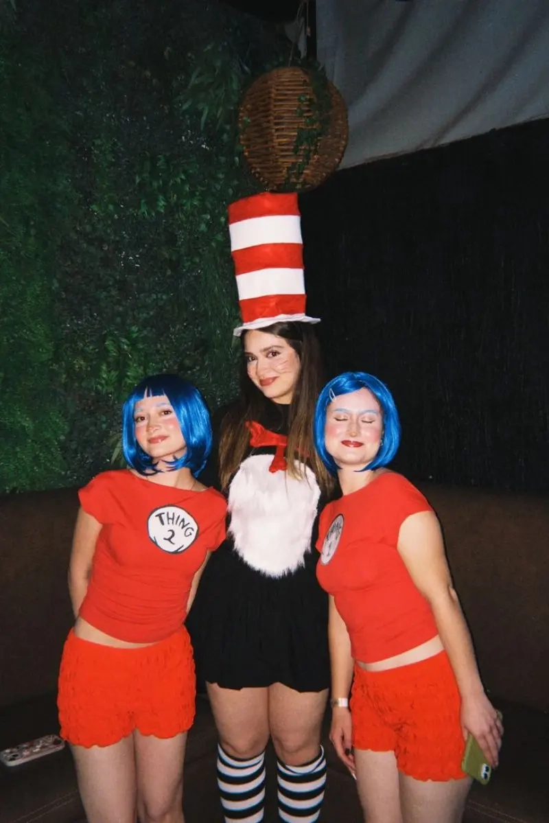 three women in cat in hat costumes red white stripes tall hat thing characters 14