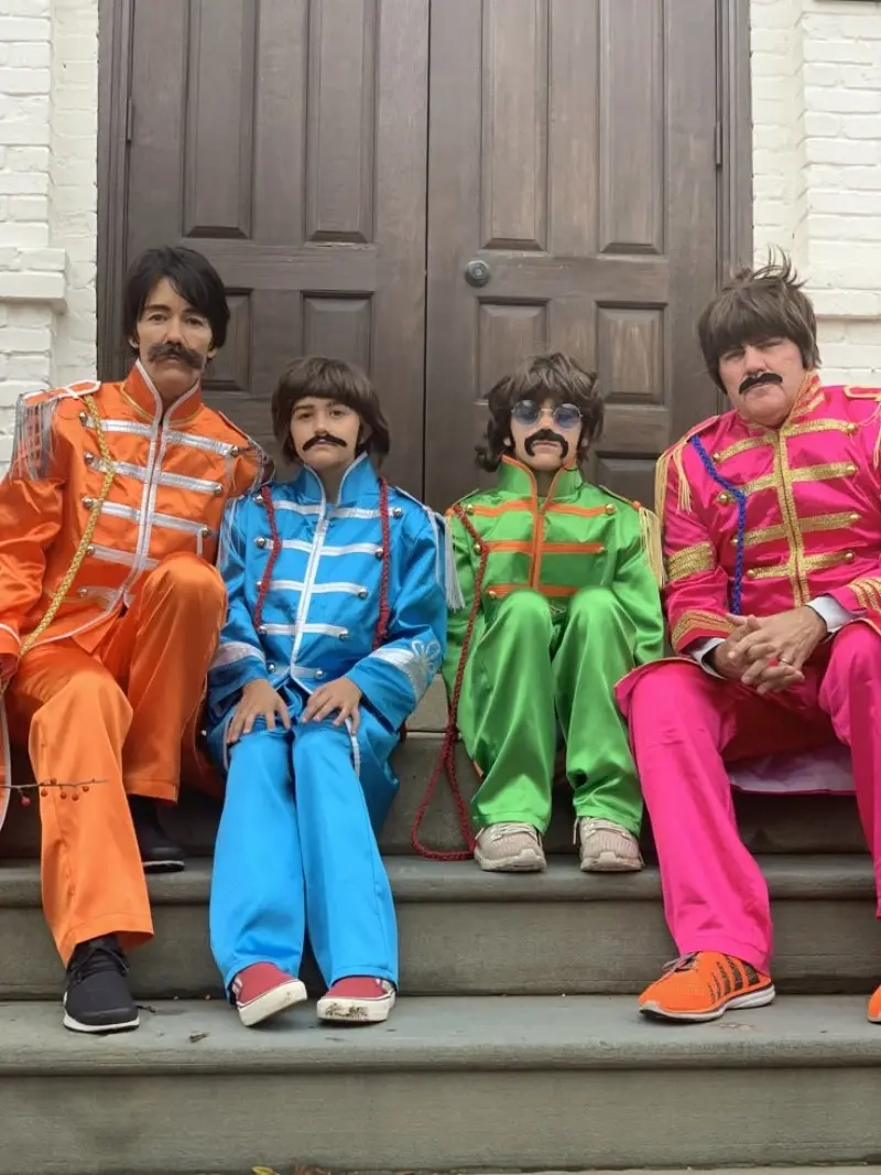 four people in beatles costumes colorful sergeant pepper jackets mustaches 10