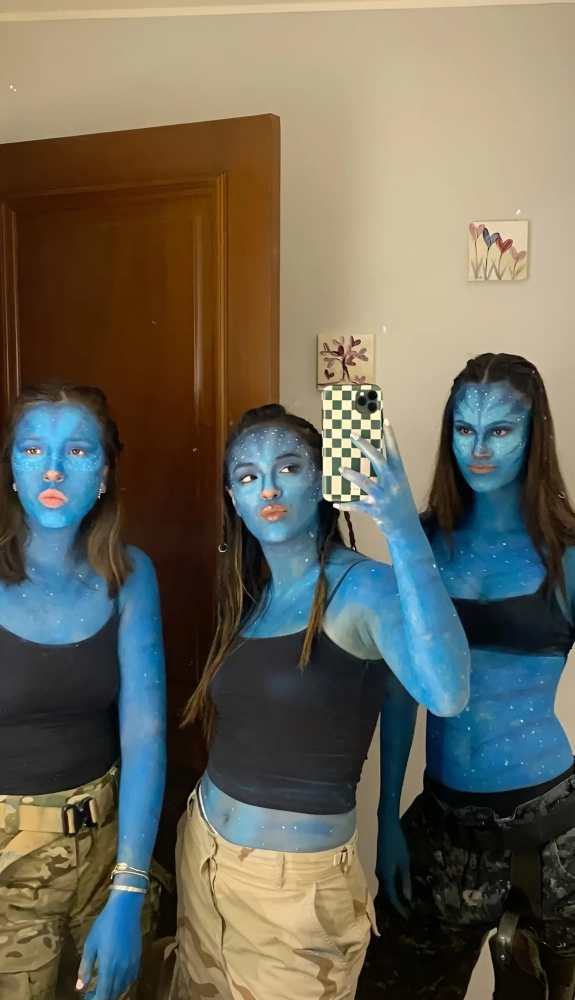 three women in avatar costumes blue body paint black crop tops 12