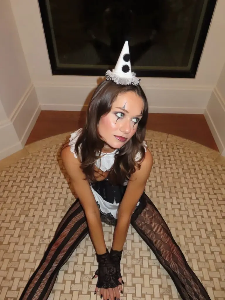 woman in black white pierrot mime costume with pointed hat and dramatic face paint 3