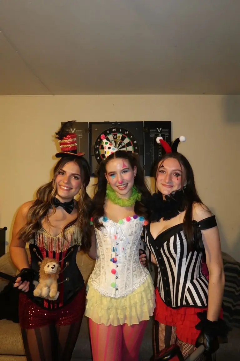three women in coordinated circus costumes with fringe clown and striped performer styles 8