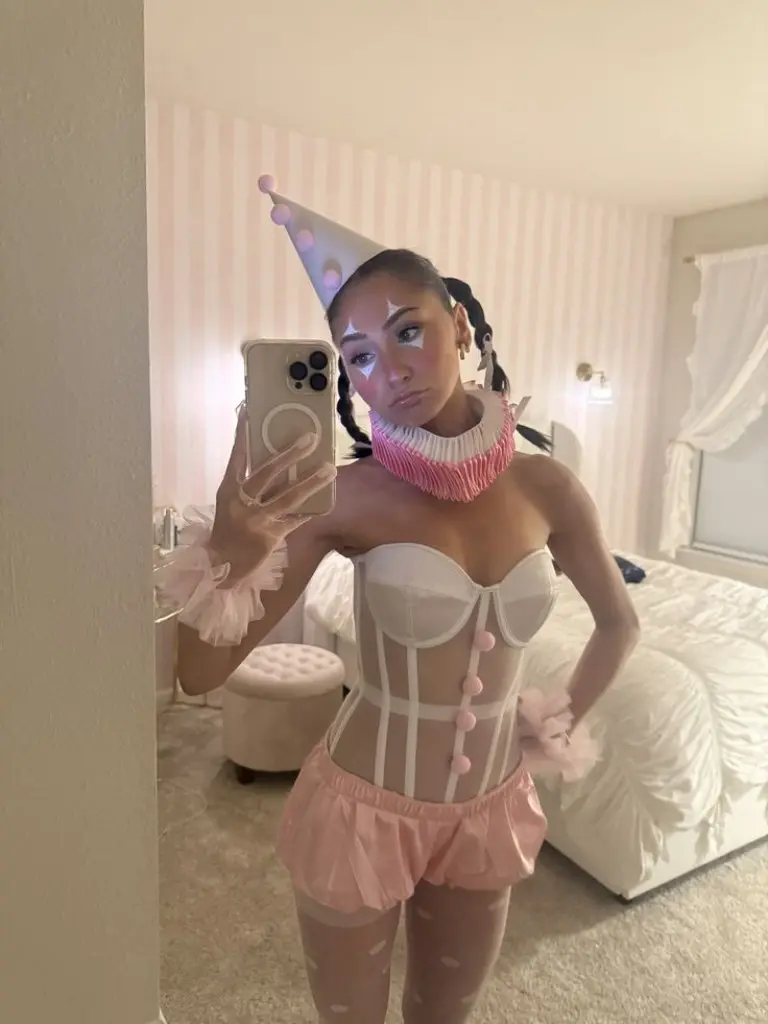 woman in pale pink white corset and shorts cotton candy circus costume with braided hair 11