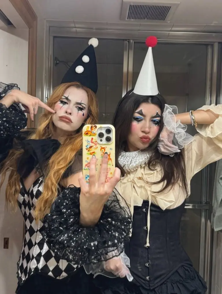 two women in distressed cream black circus costumes with dark makeup horror style performers 14