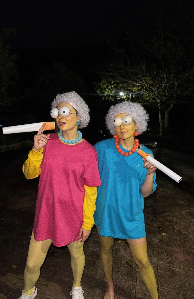 two women dressed as Patty and Selma from Simpsons with gray wigs and colorful shirts outfit 4