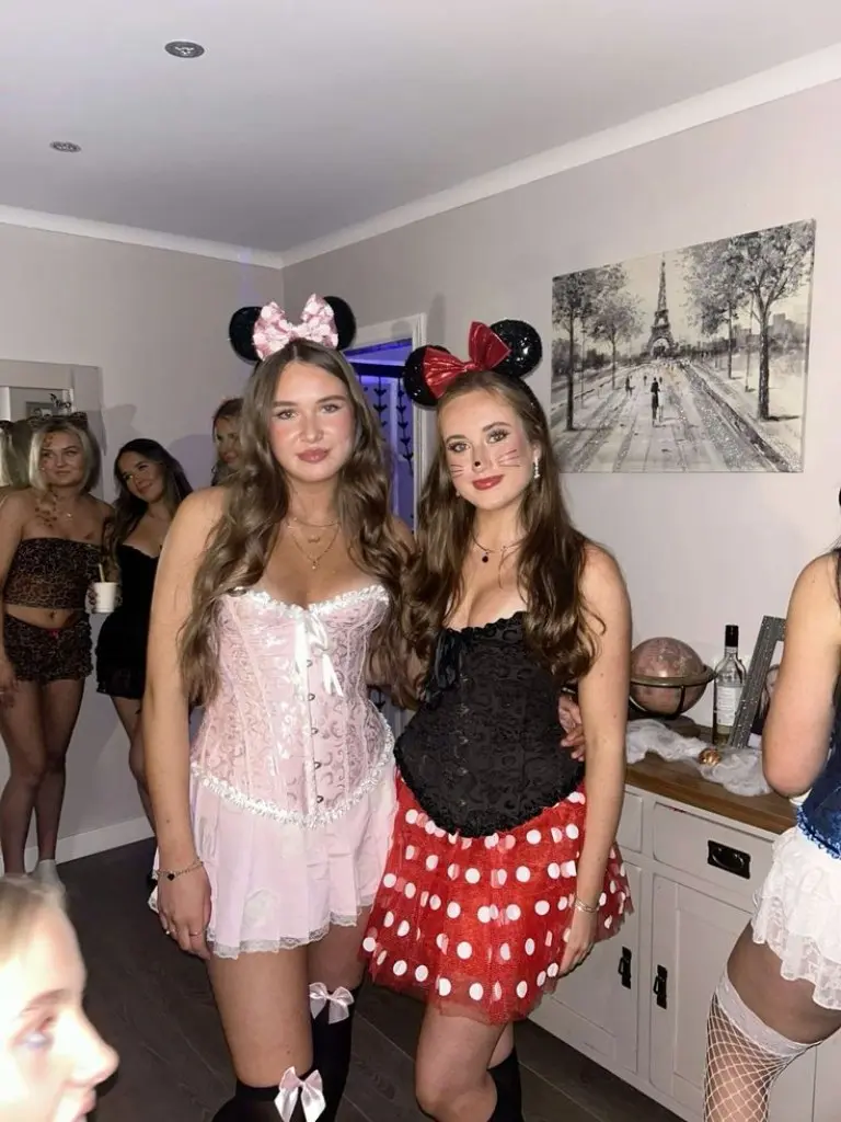 two women as different versions of Minnie Mouse with mouse ears and dresses outfit 7