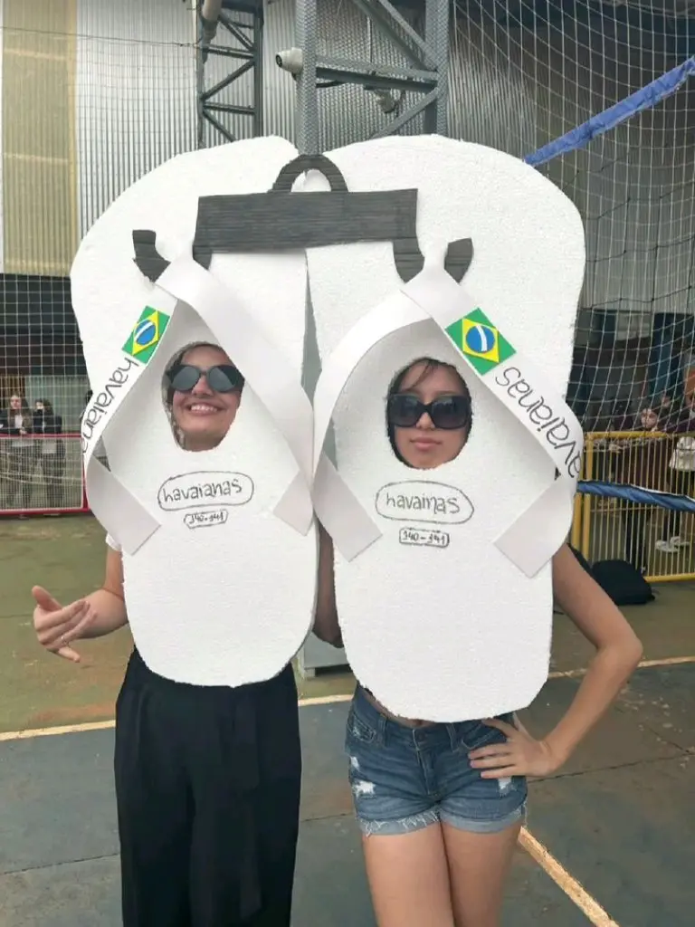 two women wearing large flip flop costumes in white outfit 8