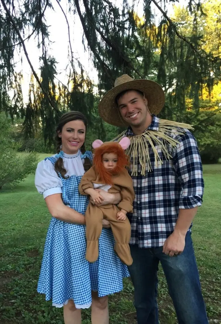 family dressed as wizard of oz characters blue dress plaid shirt straw hat baby in lion costume 3