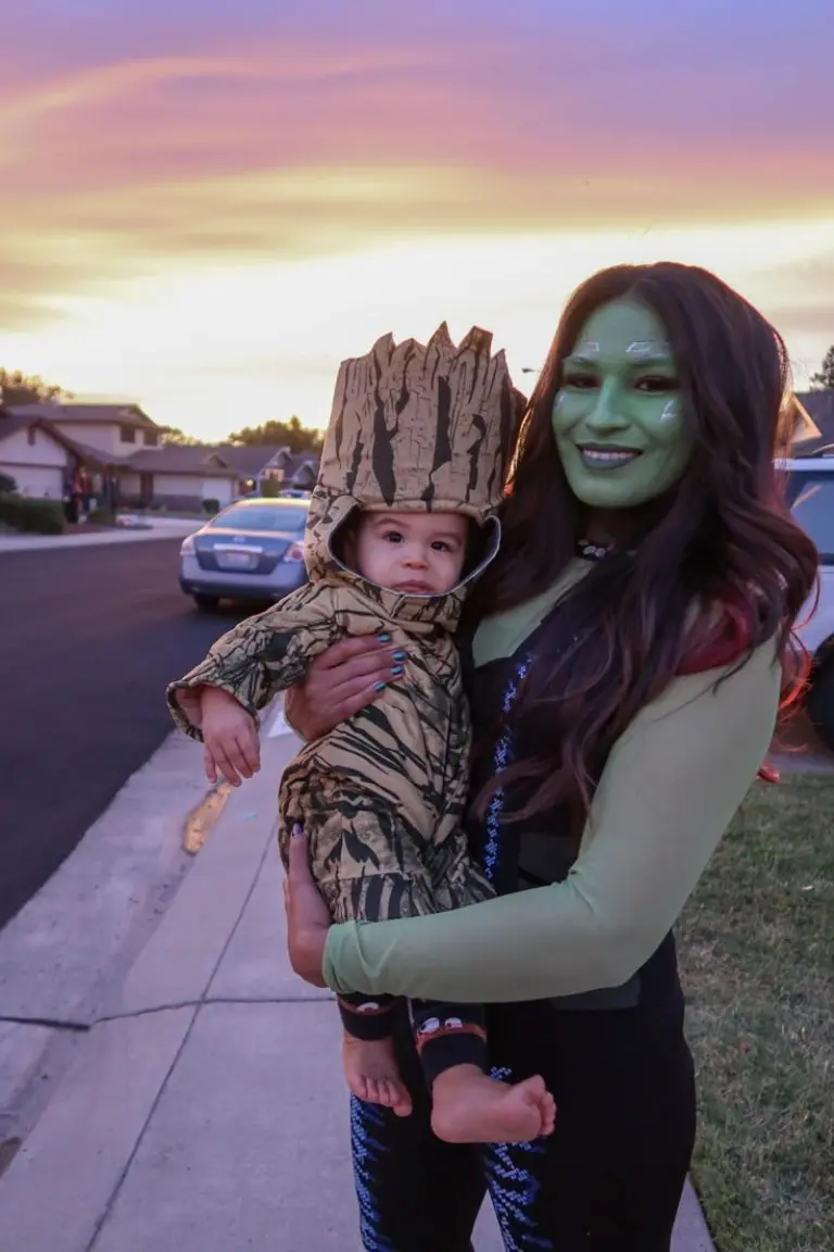 family in guardians of galaxy costumes green face paint leather jacket baby in groot tree costume 13
