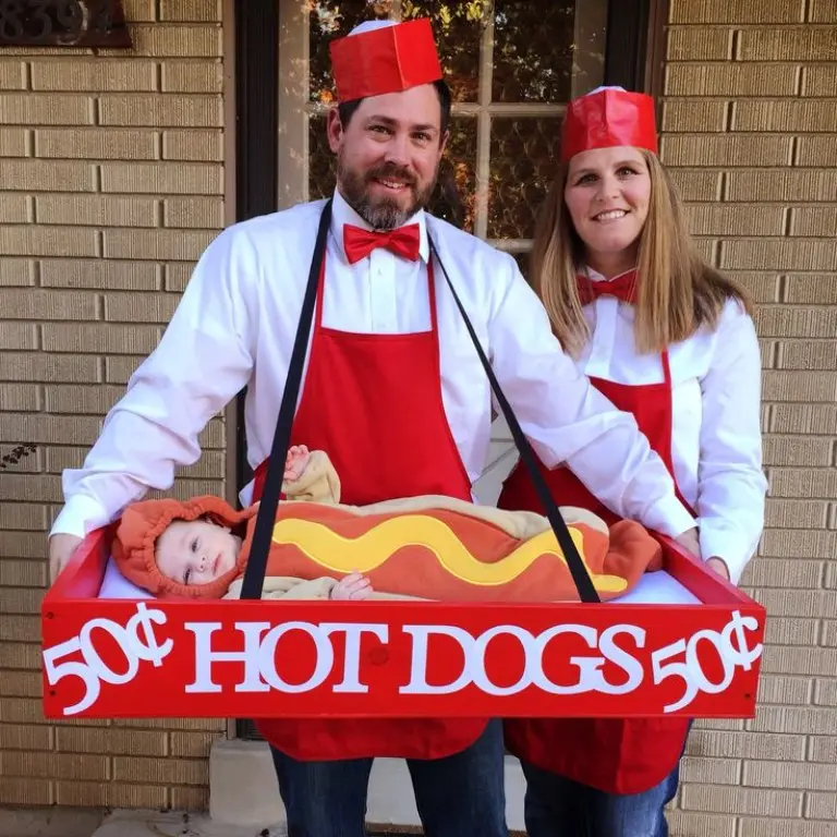 family dressed as hot dog vendors with red striped aprons baby lying in hot dog costume carrier 17
