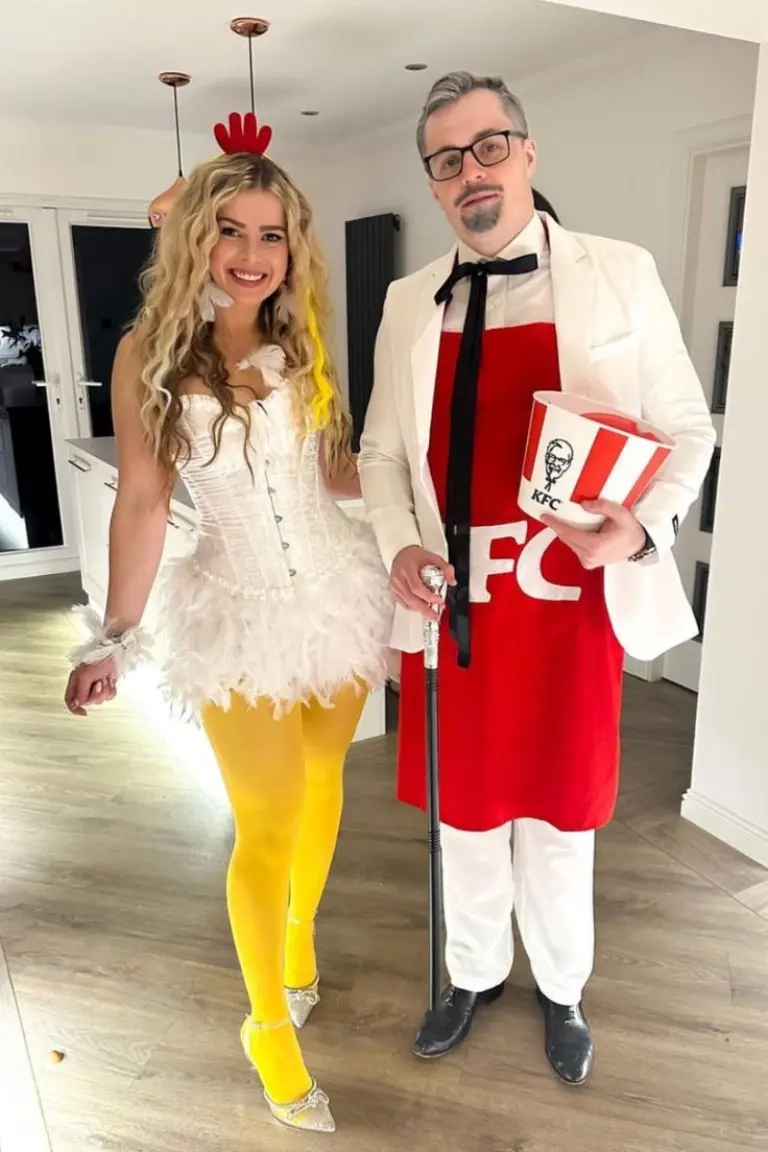 man woman both in red strawberry costumes with green leafy tops and seed details outfit 15