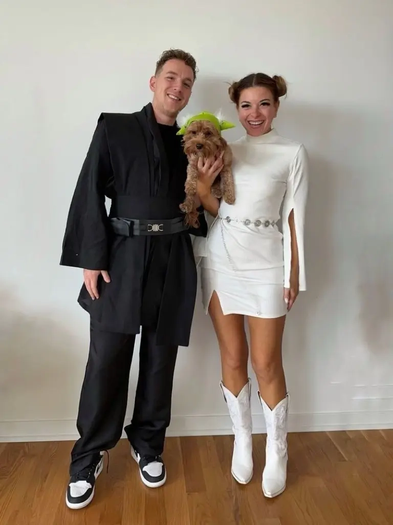 man in black outfit woman in white dress with signature buns hairstyle yoda ears dog outfit 13