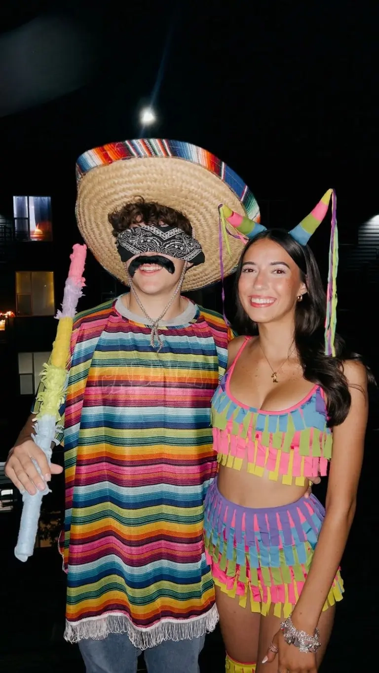 man in colorful striped poncho sombrero woman in bright colorful piñata-style dress outfit 11