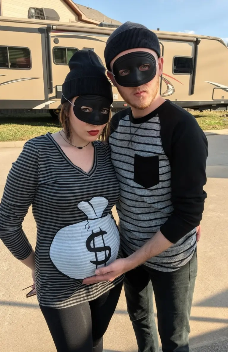 pregnant woman in sparkly silver dress with partner in white shirt black pants afro wig disco costume 10