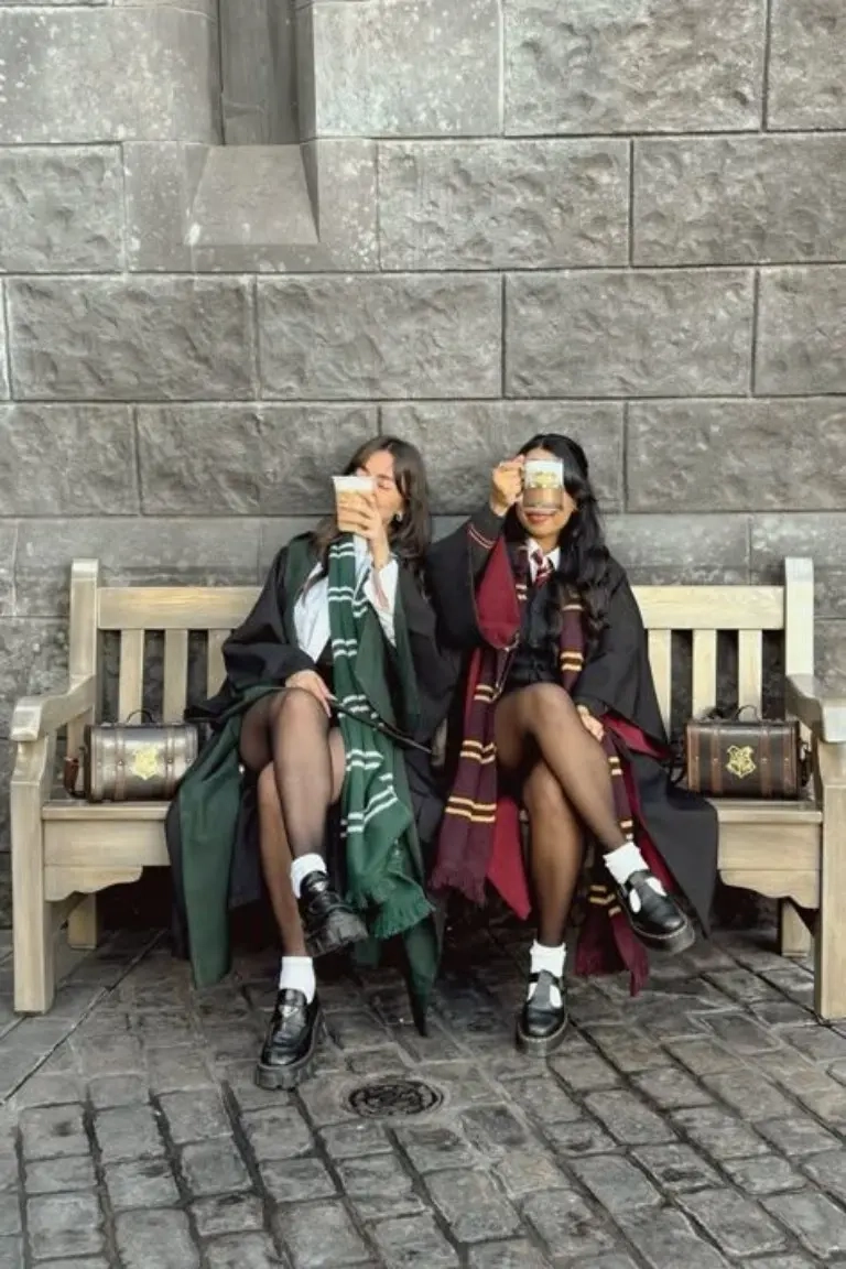 two teenage girls wearing harry potter hogwarts student uniforms with house scarves school robes outfit 7