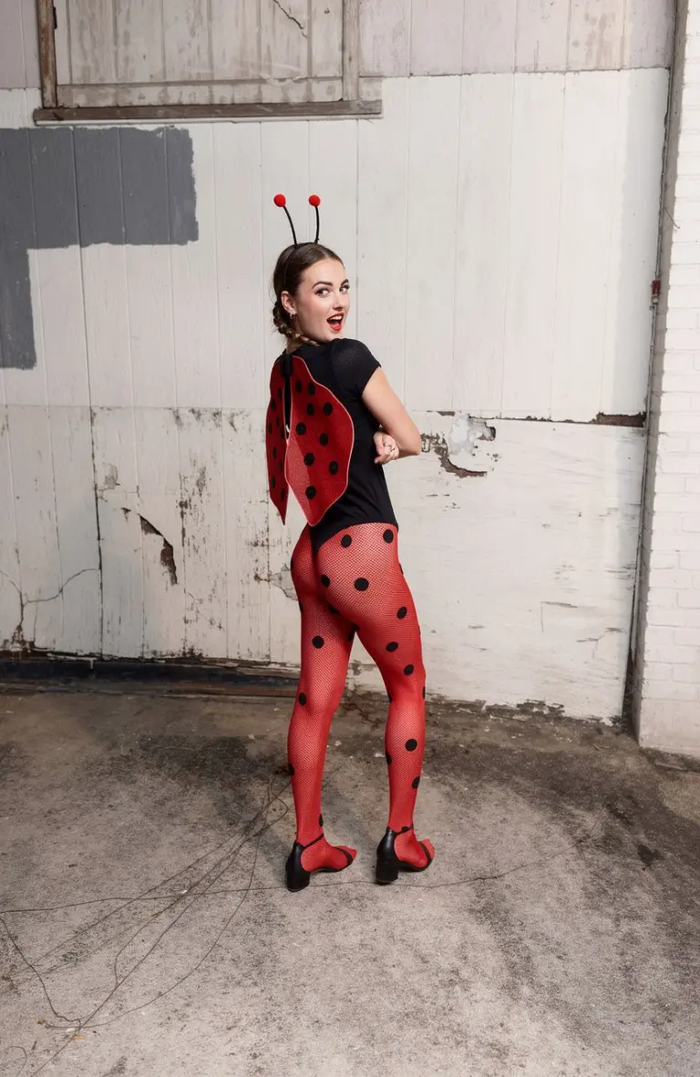 woman wearing red and black ladybug halloween costume with wings antennae and polka dot tights outfit 1