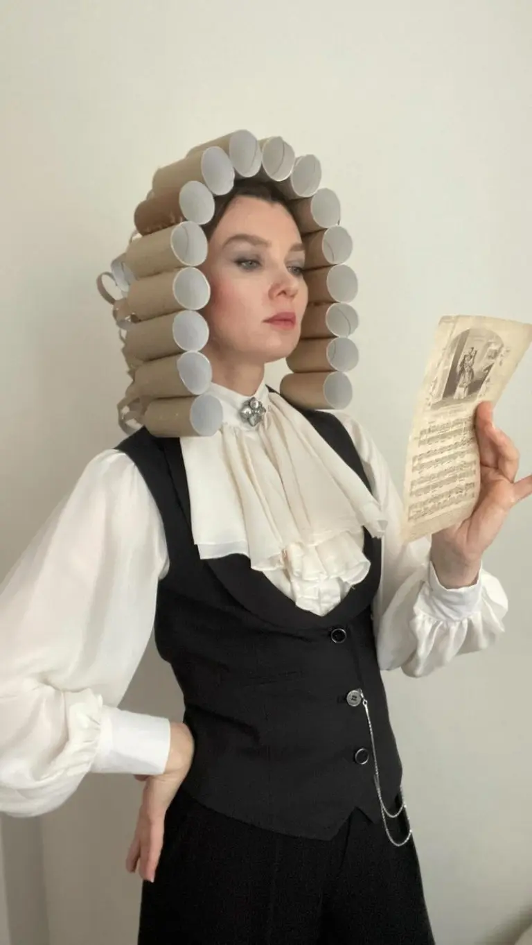 woman wearing black vest white blouse and elaborate white powdered wig georgian costume outfit 11