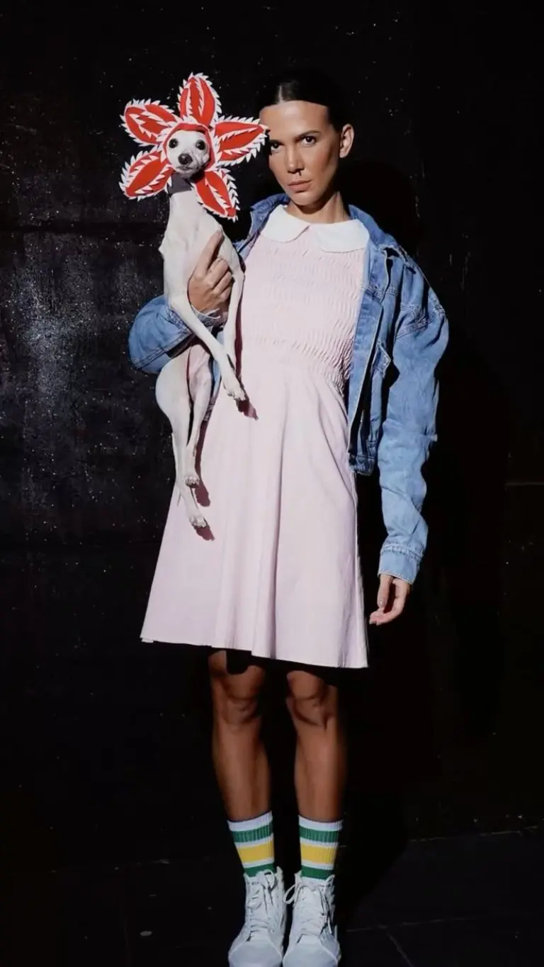 woman wearing pink dress denim jacket with stranger things prop and wavy hair costume outfit 12