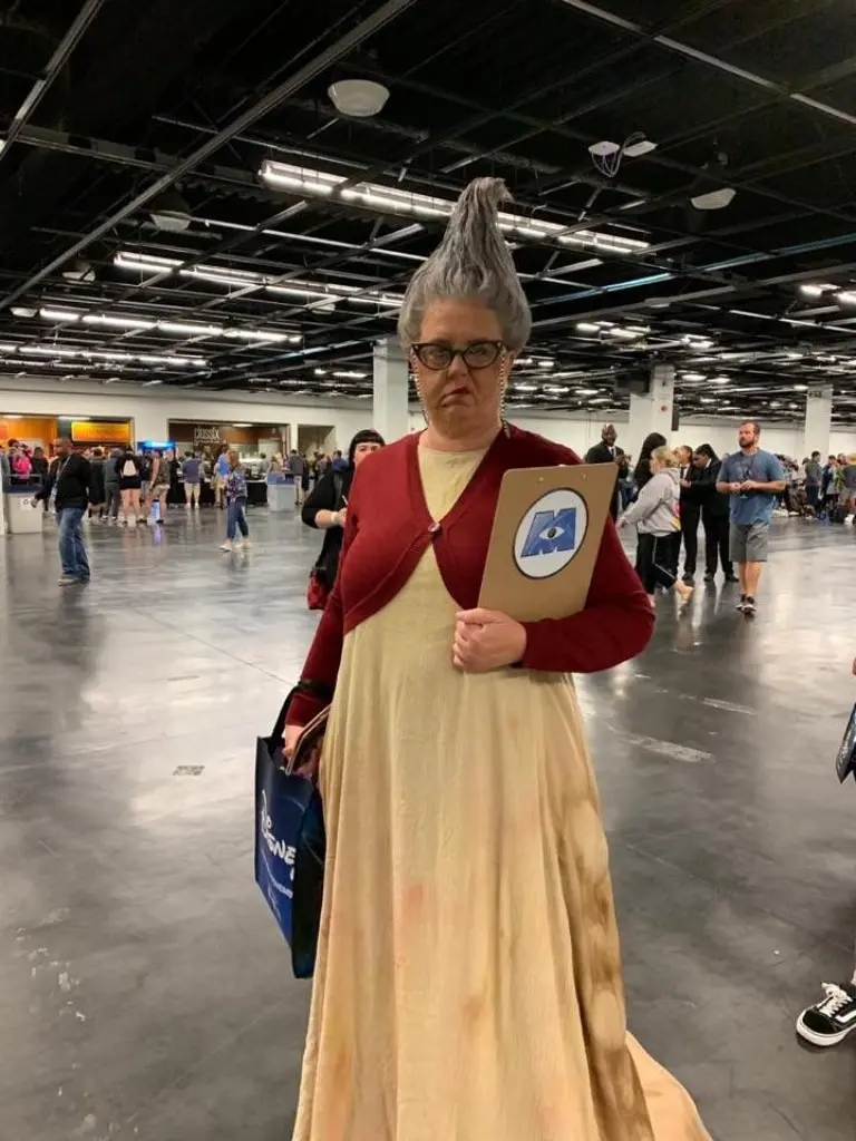 woman wearing black and yellow judicial robes with hair in bun holding gavel rbg costume outfit 16