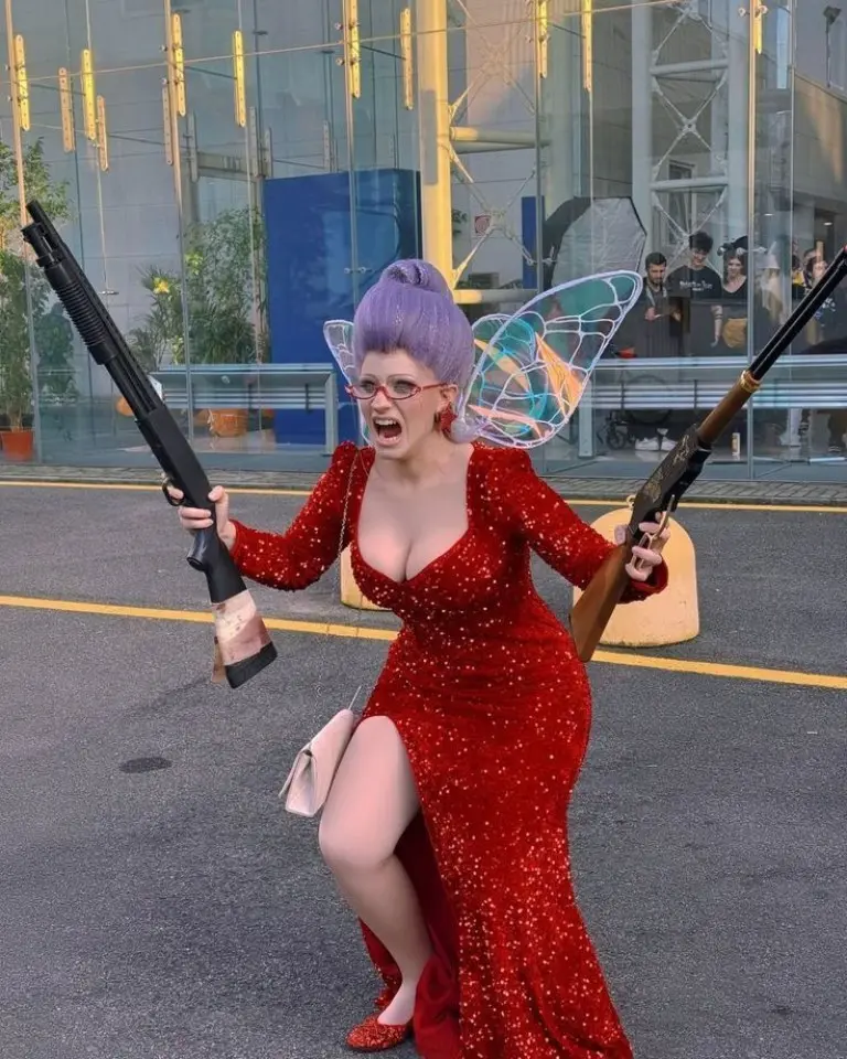 woman wearing red sequined dress with fairy wings and purple hair holding weapons costume outfit 17