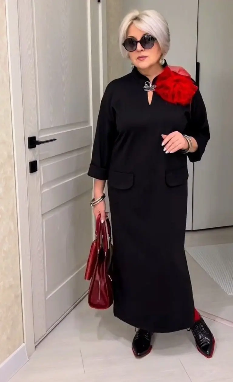 woman in black top red fur scarf black long skirt sunglasses red handbag black shoes 10
