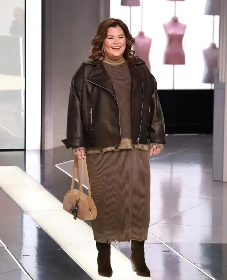 woman in black leather moto jacket brown ribbed knit dress brown handbag brown boots 18