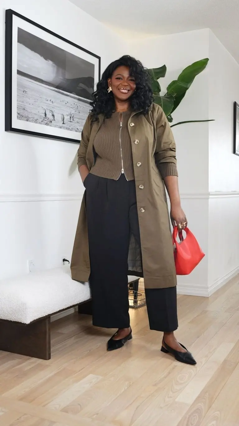 woman in olive green long duster coat ribbed top black wide leg pants red bag pointed flats 3