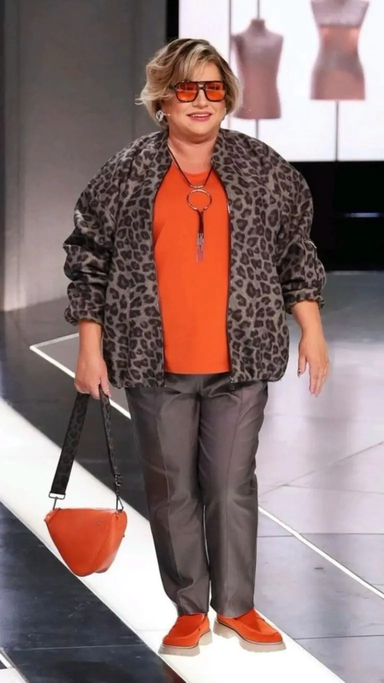 woman in leopard print blazer orange top grey pants orange sunglasses orange bag orange shoes 16