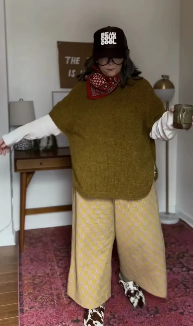 woman in mustard oversized sweater white striped shirt yellow checkered cropped pants red bandana black cap cow print shoes 20