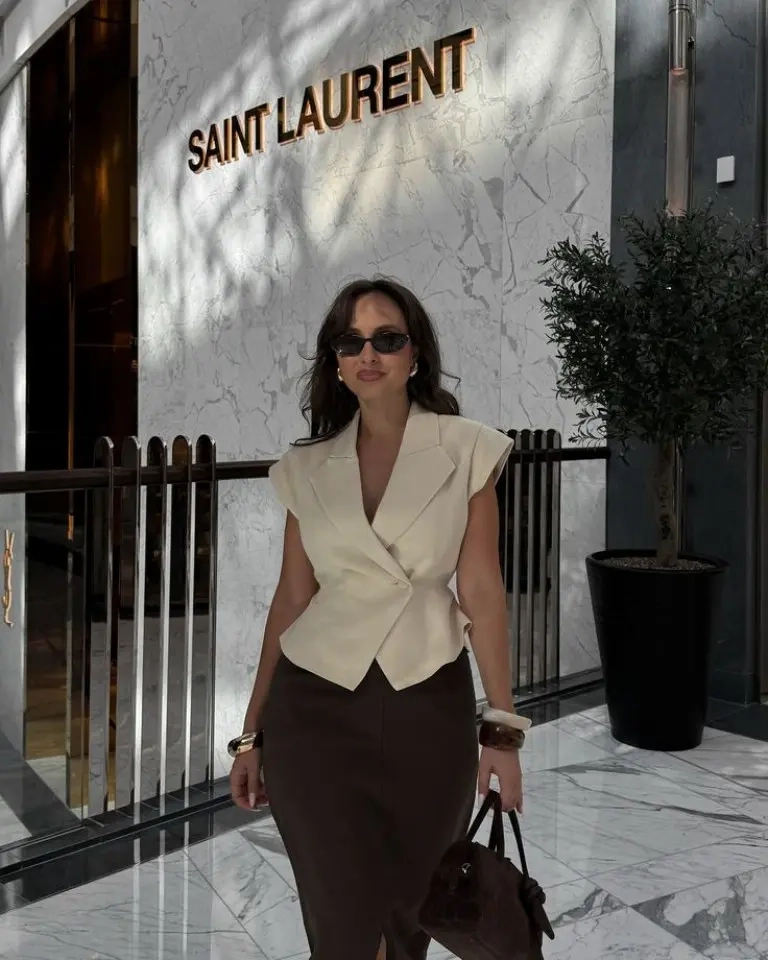 woman in cream sleeveless wrap blazer brown pencil skirt sunglasses handbag outfit 1