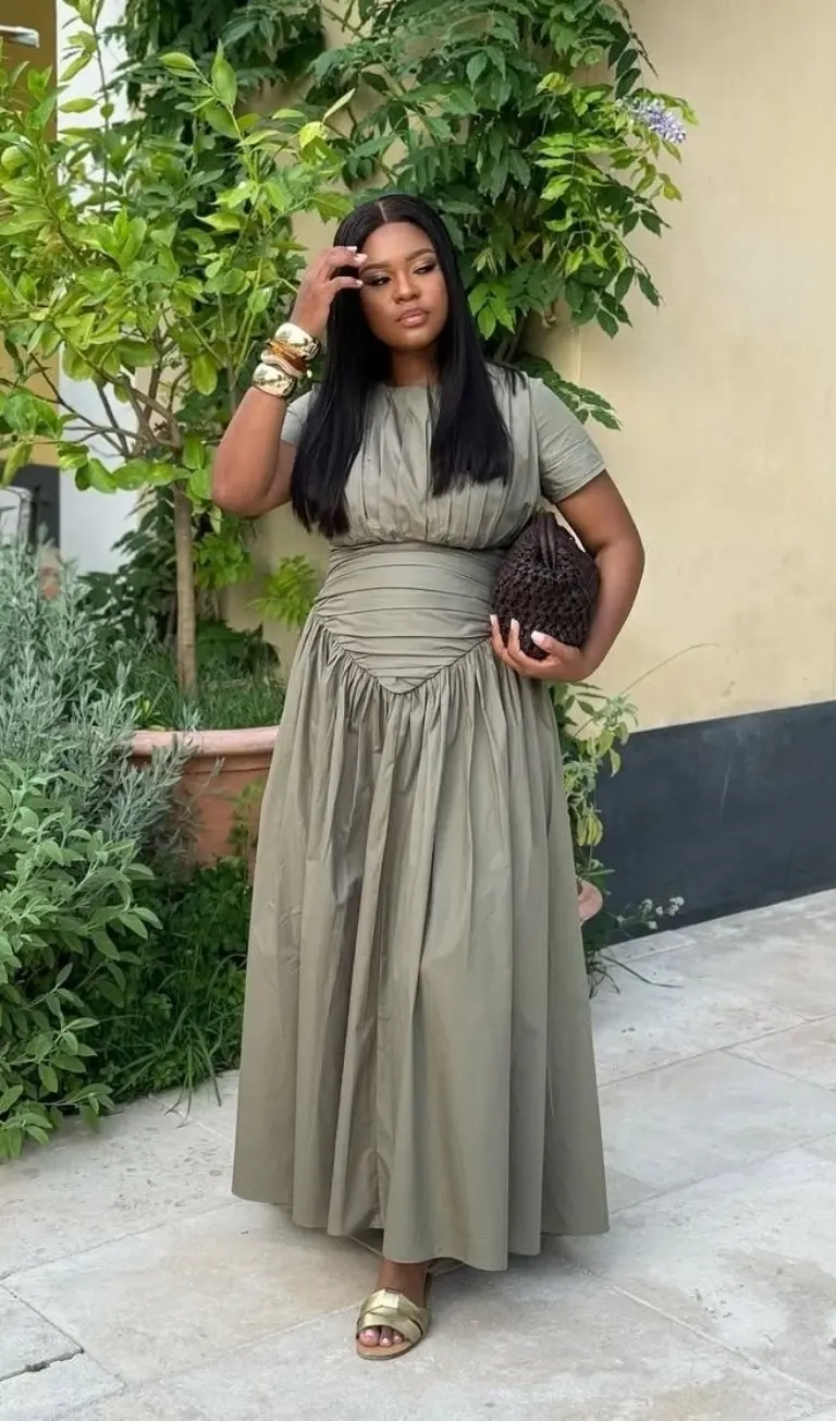 woman in olive green ruched waist maxi dress gold sandals clutch bag outfit 2