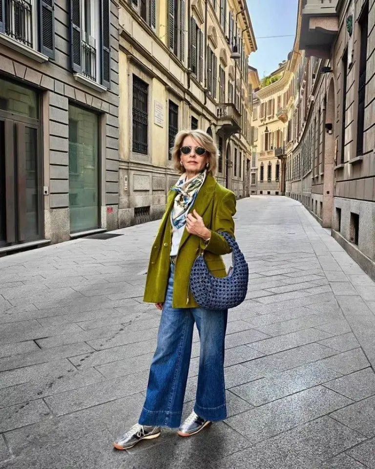 olive green blazer white top patterned scarf blue wide-leg jeans gray sneakers printed tote bag sunglasses outfit 16