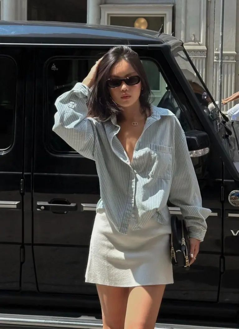 oversized striped shirt beige mini skirt sunglasses black bag outfit 3