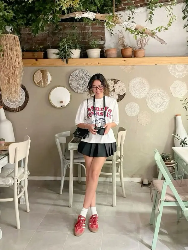 white graphic t-shirt black pleated skirt red sneakers glasses outfit 12