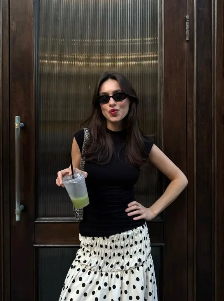 black sleeveless top white polka dot skirt sunglasses drink outfit 13