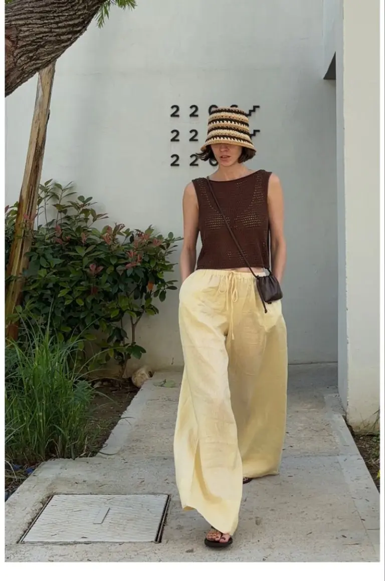 brown sleeveless knit vest beige wide leg pants bucket hat crossbody bag temple outfit 4