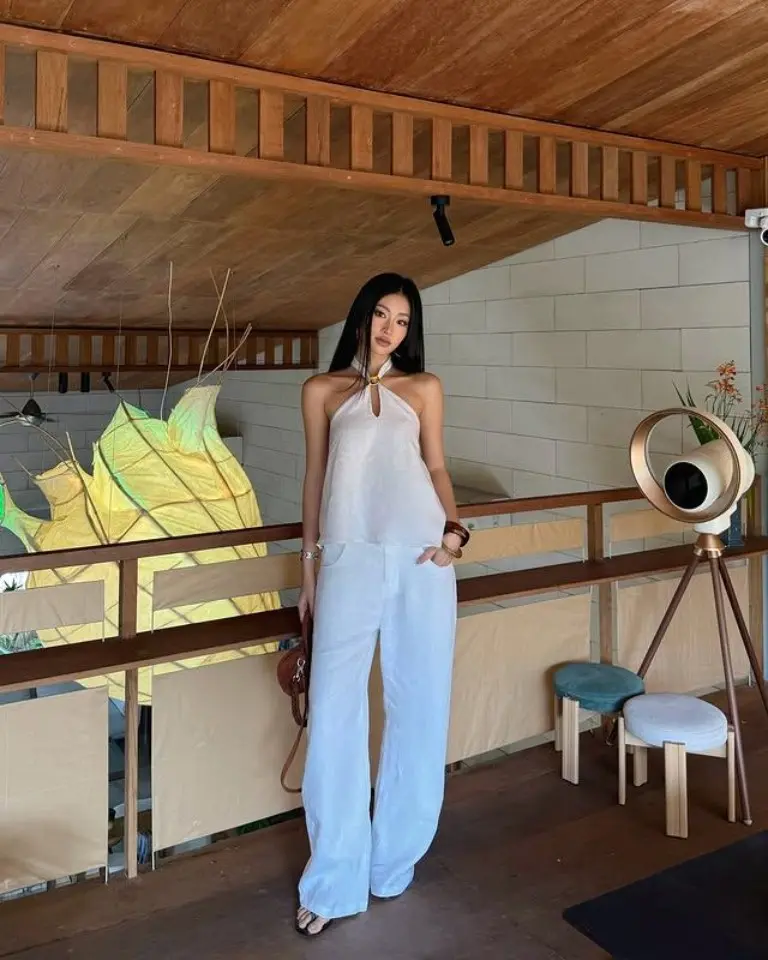 white halter jumpsuit wide leg modern resort balcony ocean view luxury outfit 12