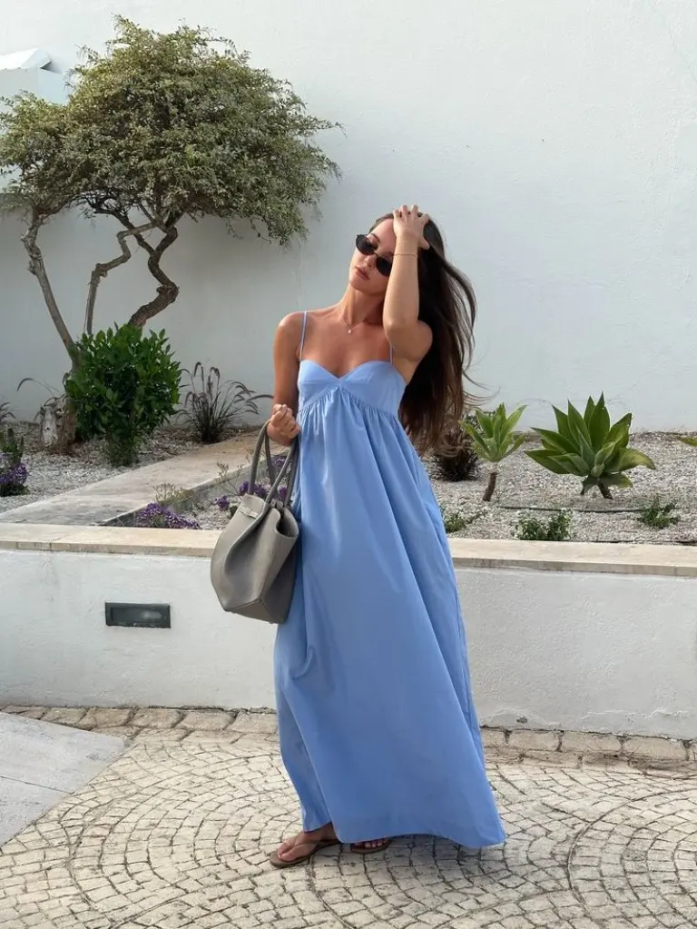 blue maxi dress with spaghetti straps and grey handbag on cobblestone street outfit 1