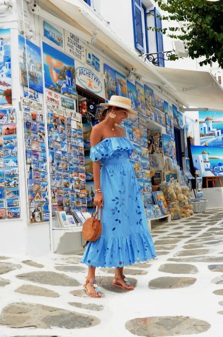 blue eyelet off-shoulder dress with straw hat and woven bag on cobblestone street outfit 5