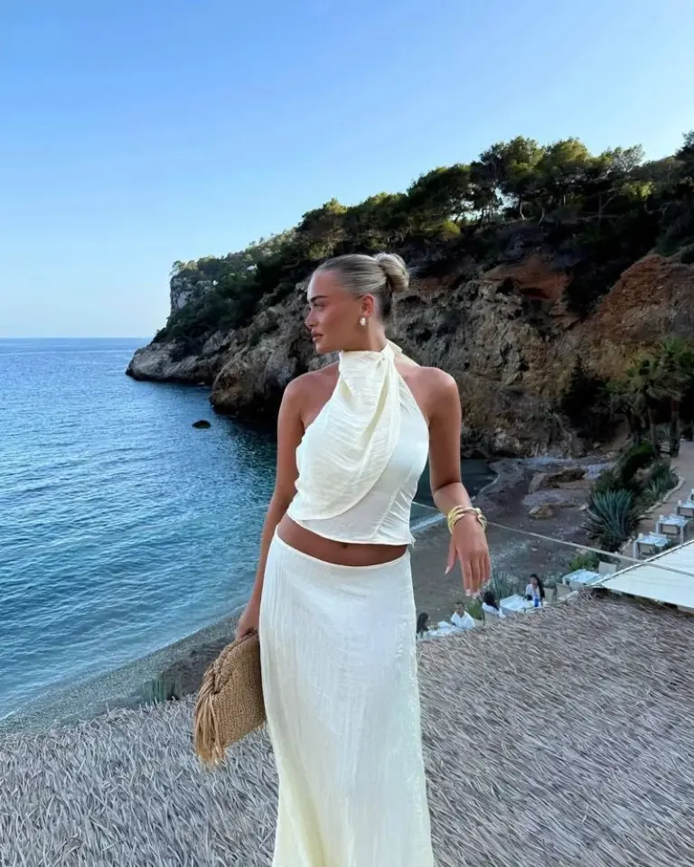 cream halter top and maxi skirt set with woven bag overlooking rocky coastline outfit 17
