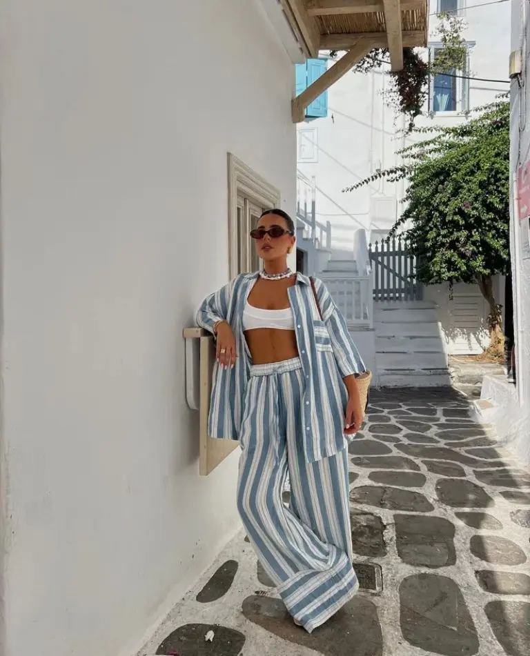 blue and white striped shirt and pants set with white crop top and pearl necklace outfit 18